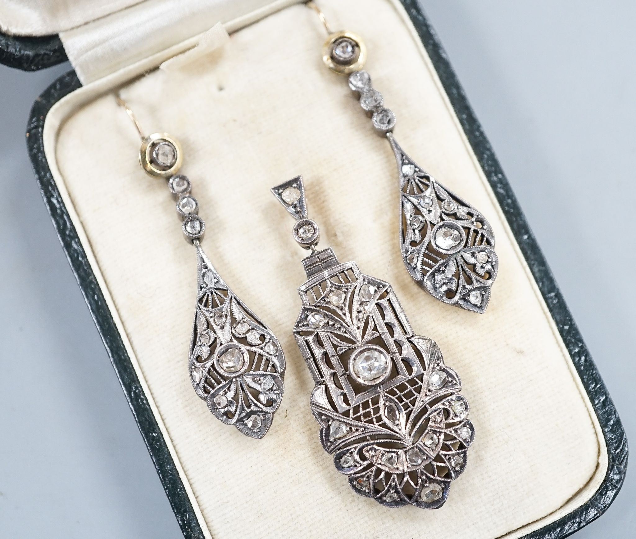 A 19th century pierced white and yellow metal and rose cut diamond set suite of jewellery, comprising a pendant 48mm and a pair of matching drop earrings, gross weight 11.2 grams.